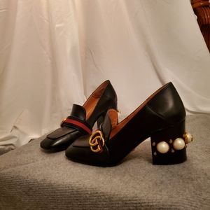 GUCCI double G heeled loafers with pearl details.